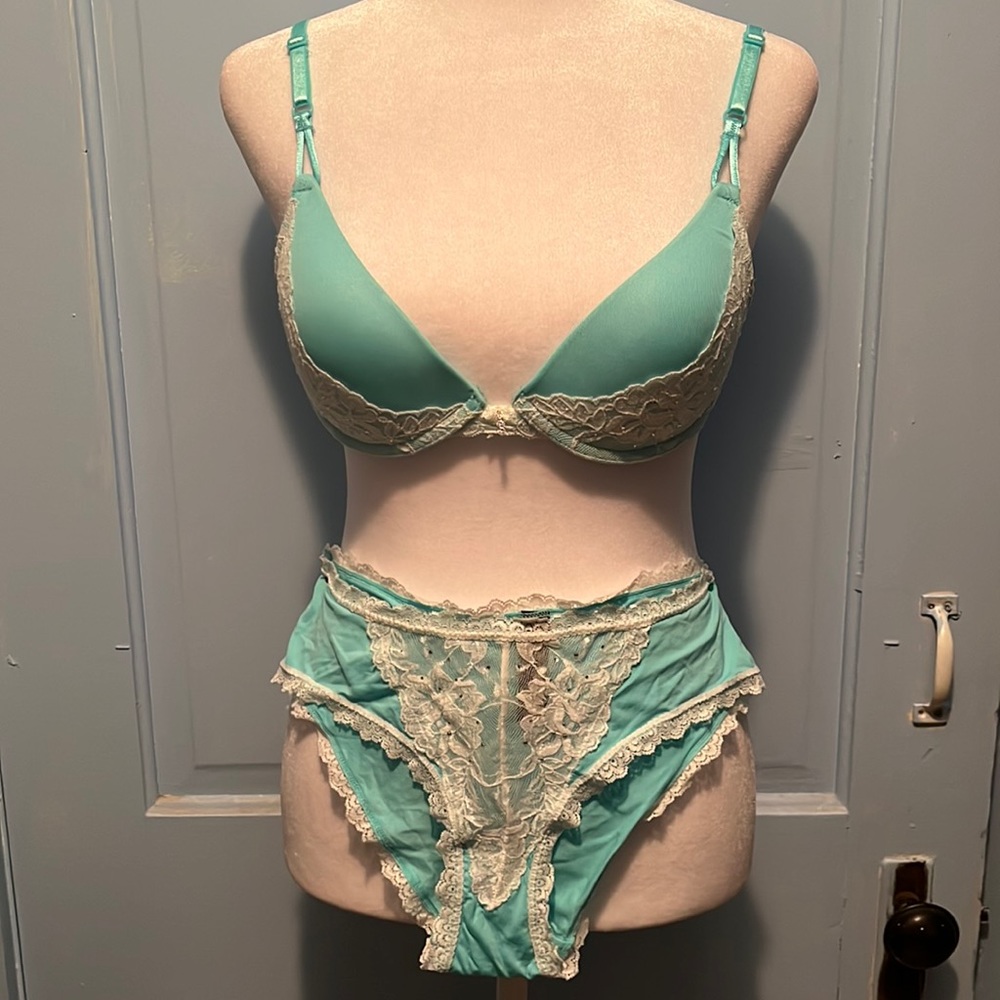 Baby blue padded push-up bra with rhinestones throughout on white lace.